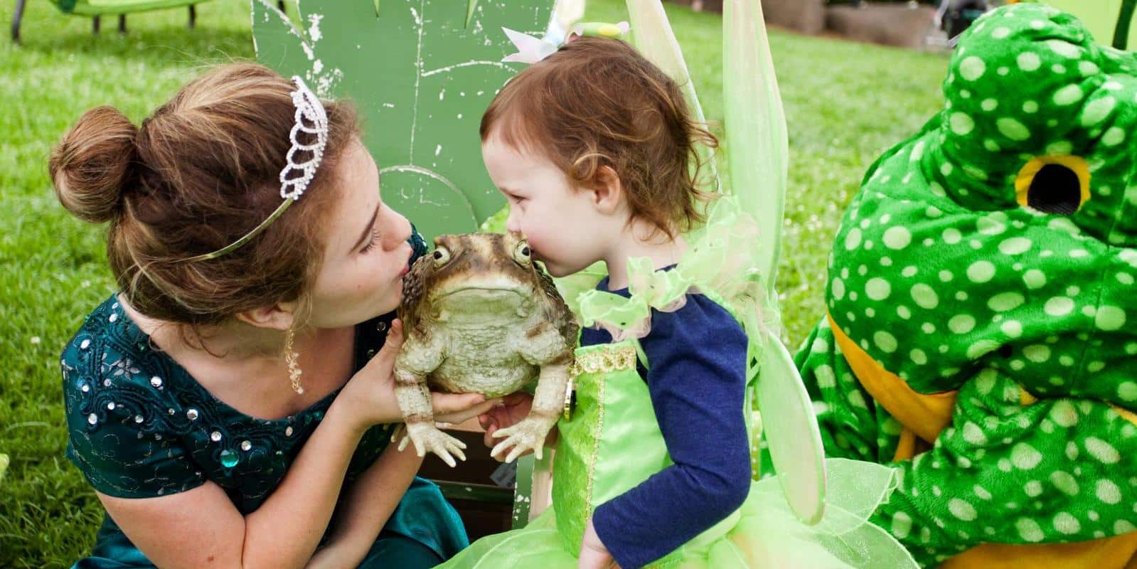 little girl and princess kiss a fake frog